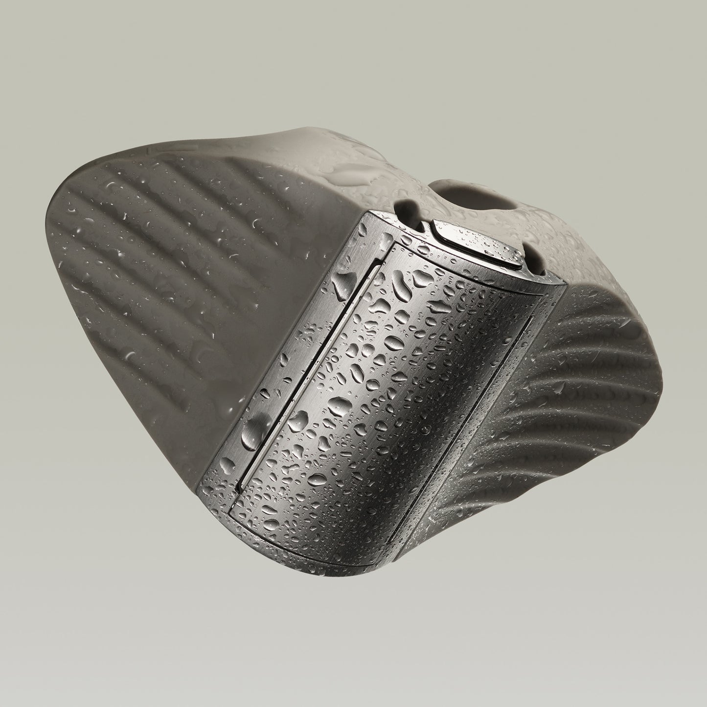 Black textured object with water droplets on a gray background